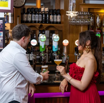 Couple enjoying drinks at a cosy hotel bar