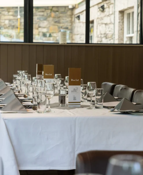 Elegant dining table set for a family gathering in a rustic hotel restaurant.