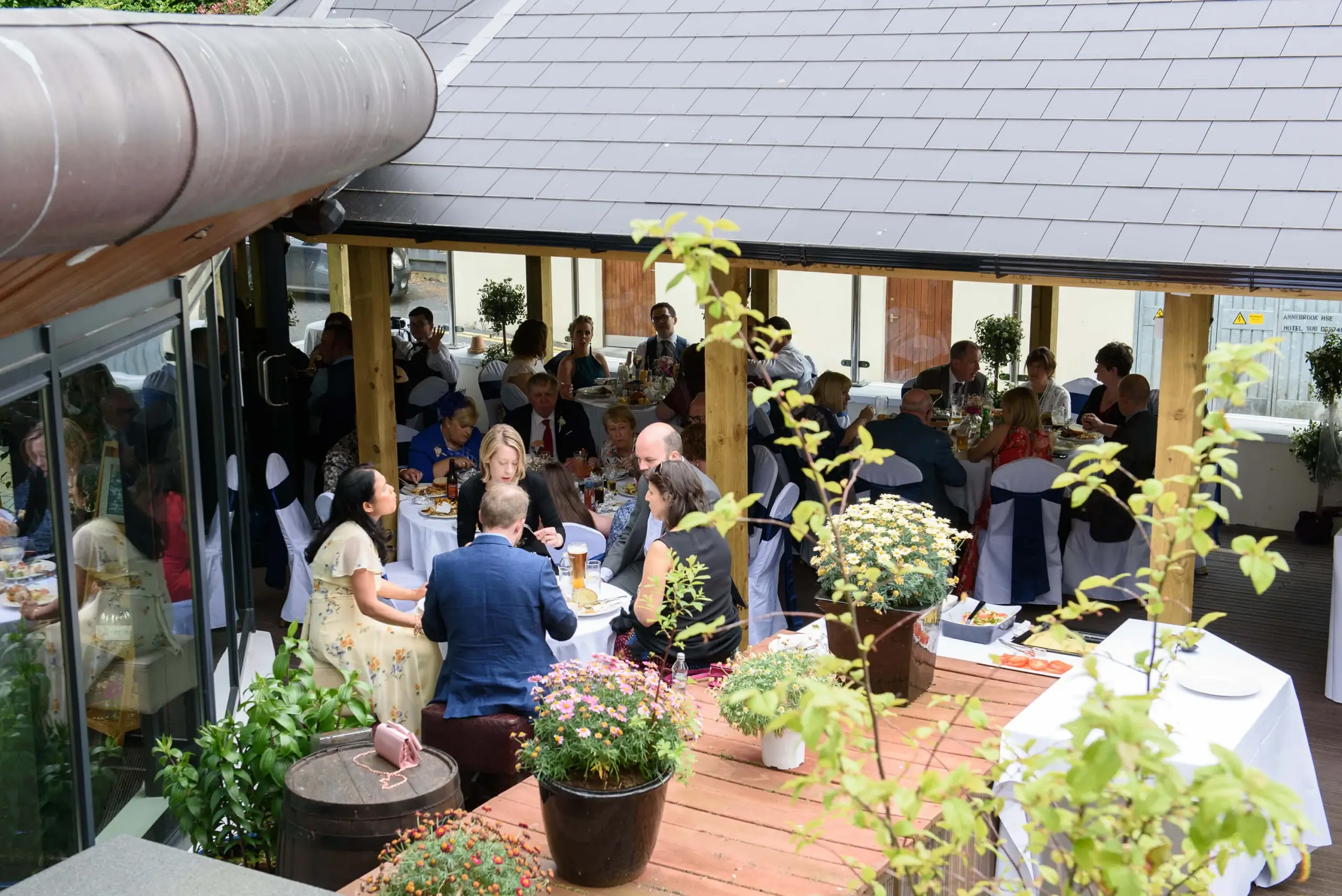 A joyful gathering in a cosy outdoor setting with family dining at a hotel resort.