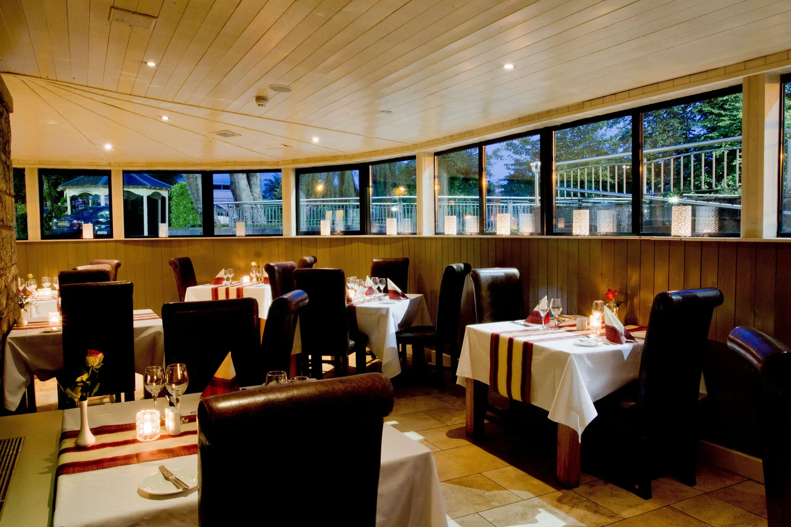 Elegant restaurant dining area with cosy tables set for an intimate dinner.
