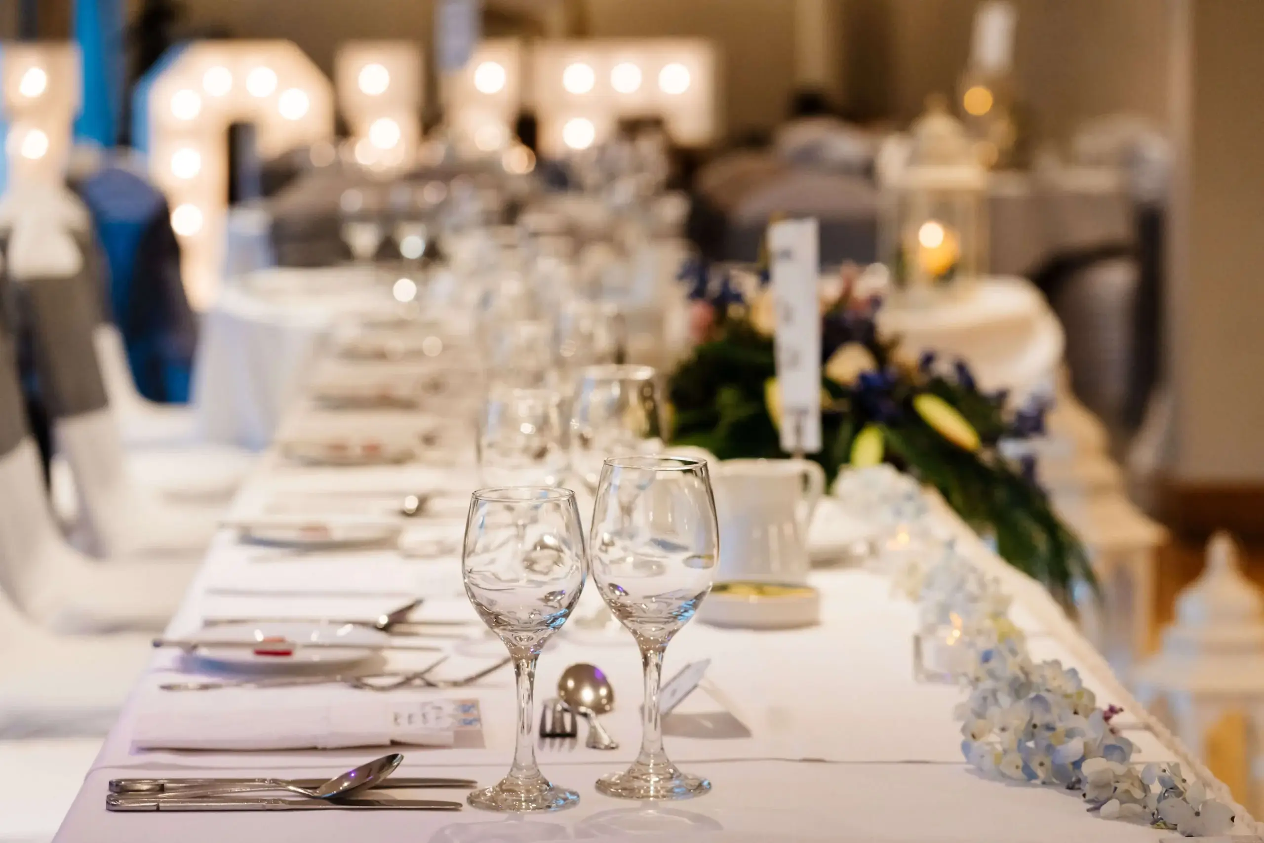 Elegant dining table set for a joyful gathering in a hotel banquet hall.