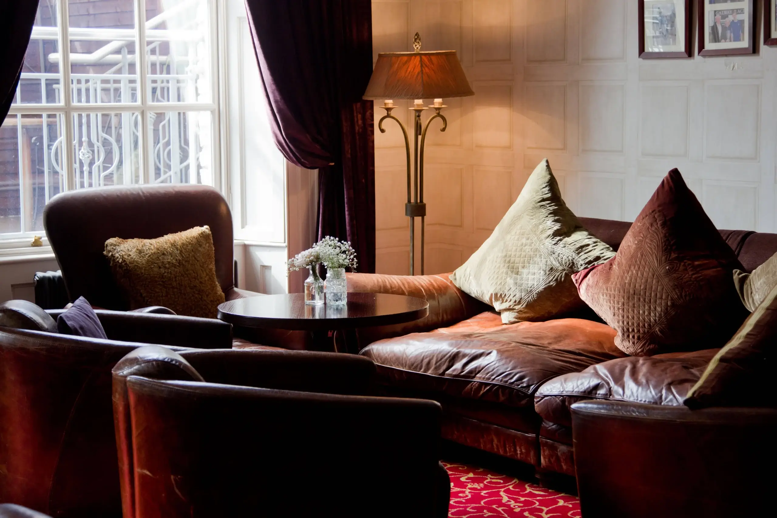 Cosy hotel lounge with plush sofas, soft cushions, and a warm, inviting atmosphere.