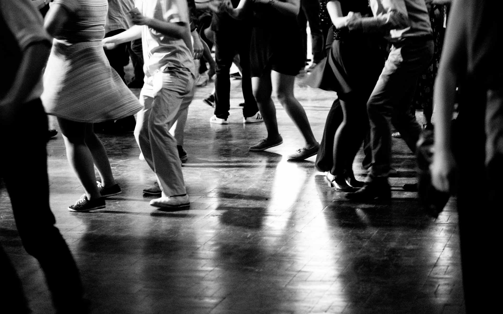 Guests dancing joyfully at a lively hotel event.