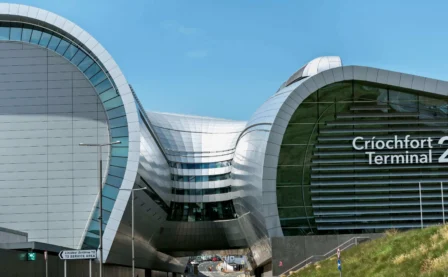 Modern architectural design of a terminal building under a clear blue sky.